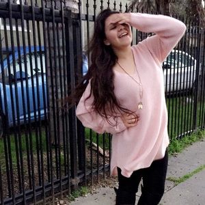 Long knitted pink sweater used as dress